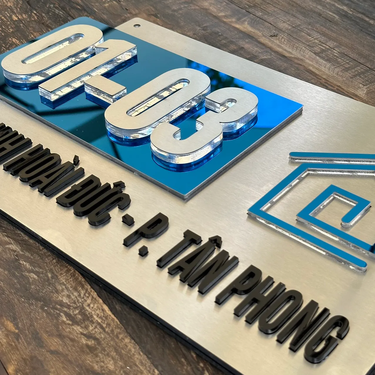 Cận cảnh chữ số nổi 3D inox trên nền xanh gương – Bảng Hiệu Vàng Chi tiết chữ nổi 3D inox 304 trên bảng số nhà xanh gương cao cấp