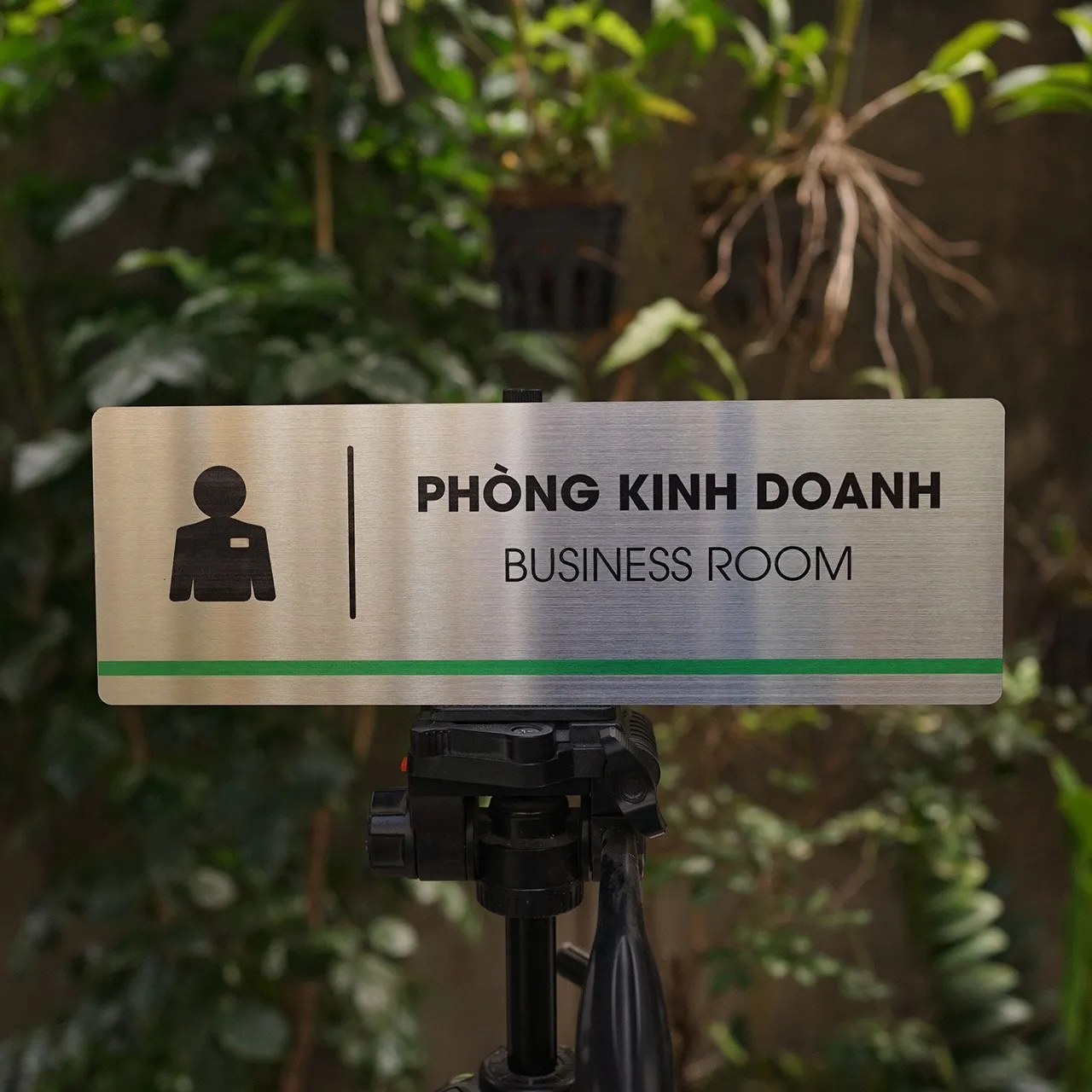 Bảng Tên Phòng Kinh Doanh Inox 304 – Mặt Trước Thẳng Thấy Rõ Sọc Xanh Lá Bảng tên phòng kinh doanh inox 304 trên giá đỡ mặt trước thấy rõ sọc xanh lá và pictogram